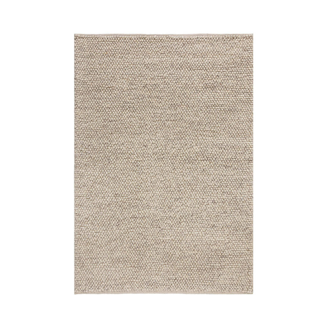 tapis en laine bouclee beige sur fond blanc#couleur_beige